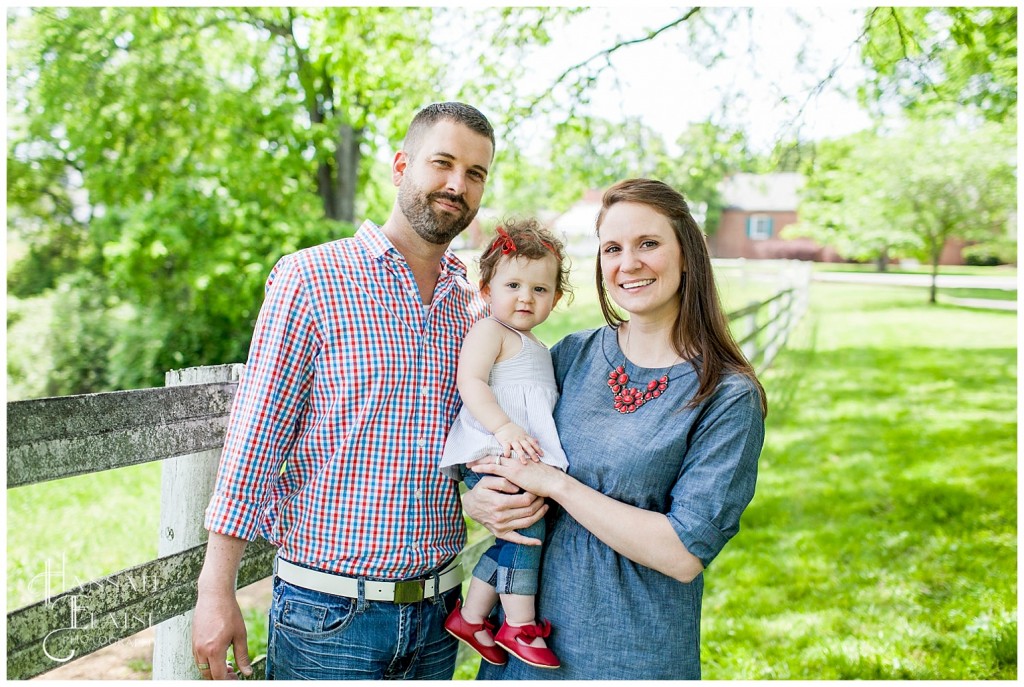 family portraits at the park next to the fence