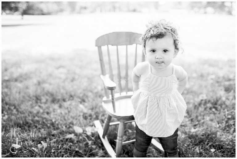 black and white photo of little girl and rocking chair