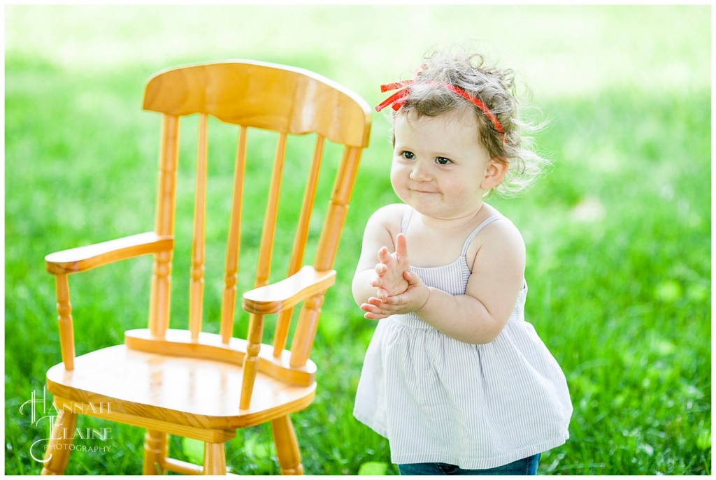 gracey hangs out next to her kiddie rocking chair