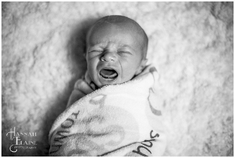 black and white photo of newborn baby crying