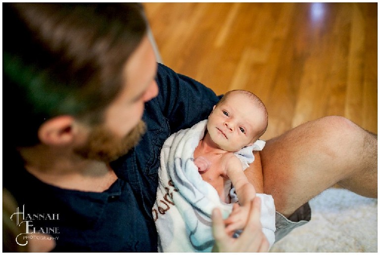 shot from above of dad holding baby son