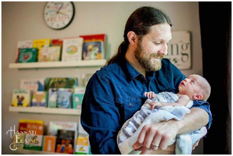 daddy holds his baby boy in new nursery