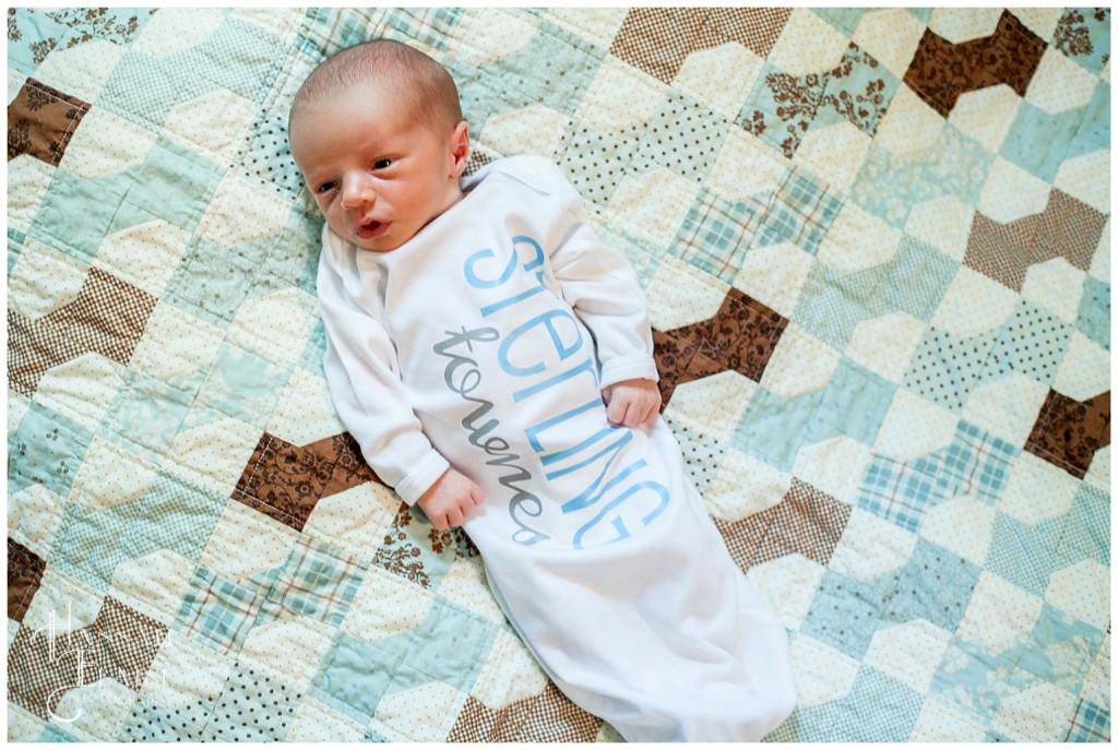 sweet little newborn boy in monogrammed onesie