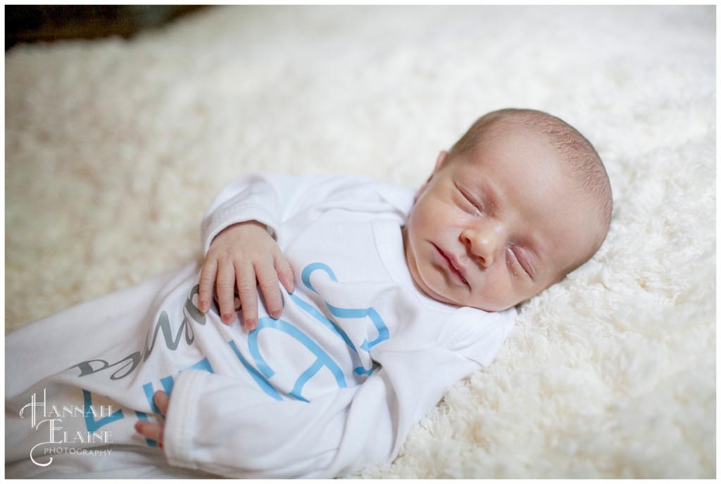 sleeping newborn on fuzzy white rug