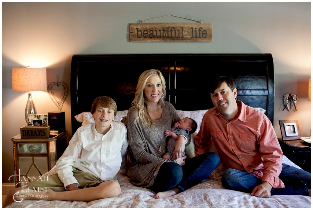 family portraits with new baby on mom and dad's bed