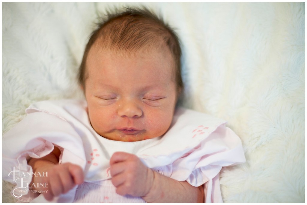 newborn naps on cozy white blanket