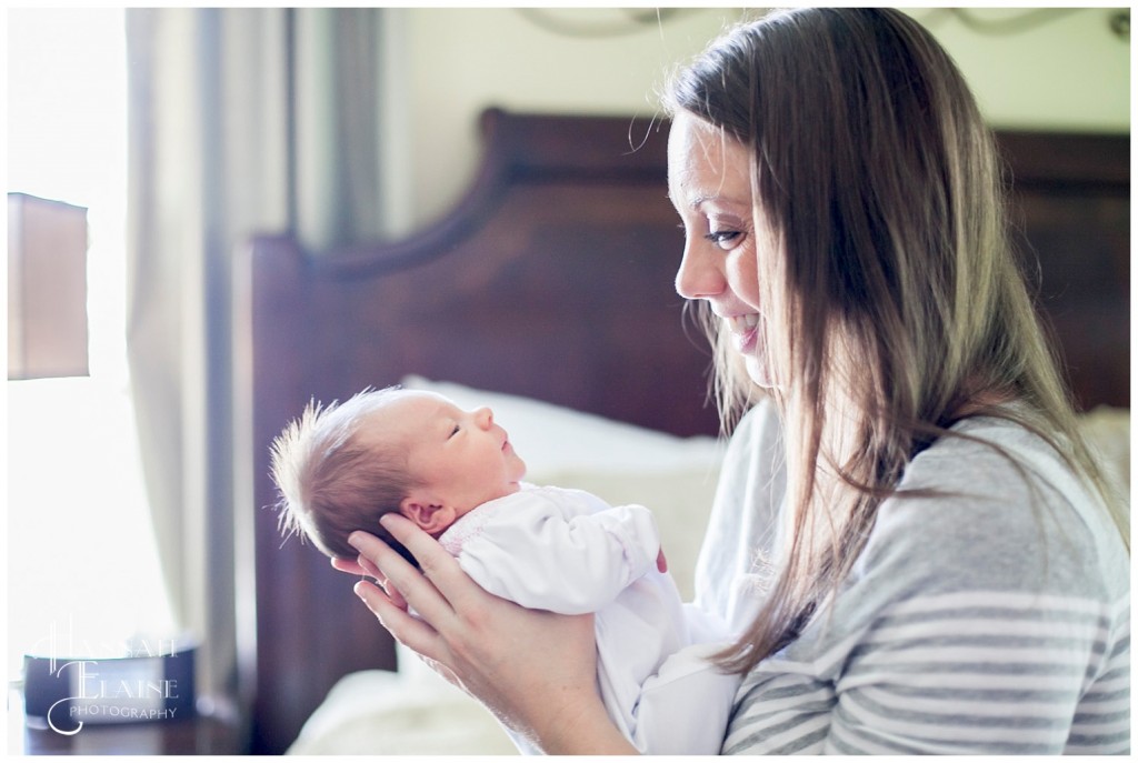 mother smiles at her tiny daughter