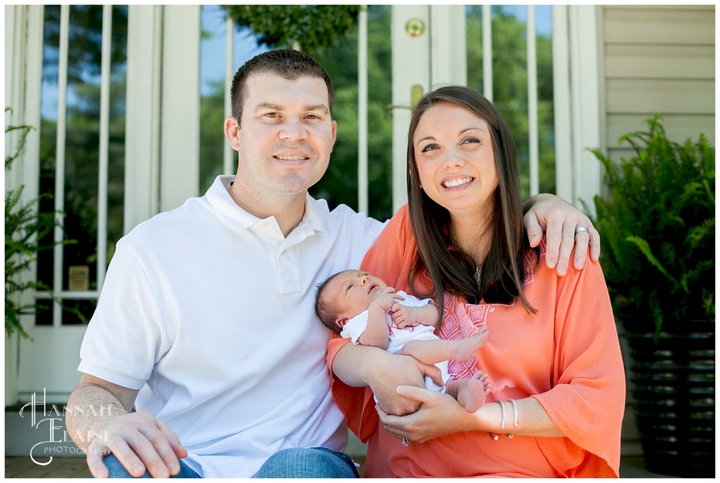 mom and dad show off their newborn daughter