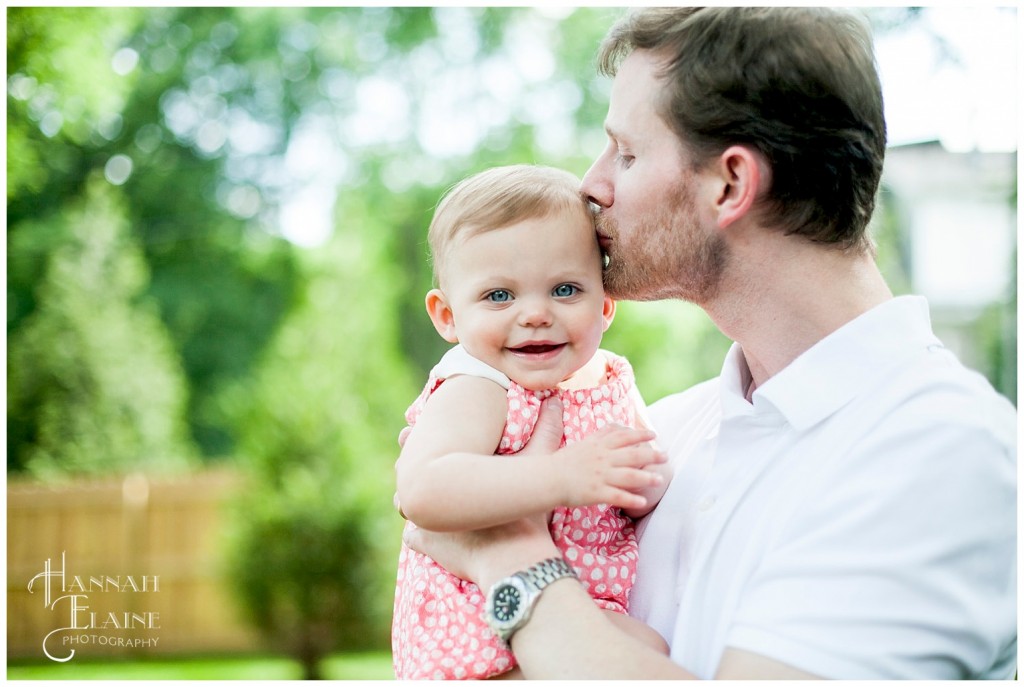 dad kisses the birthday girl on the head