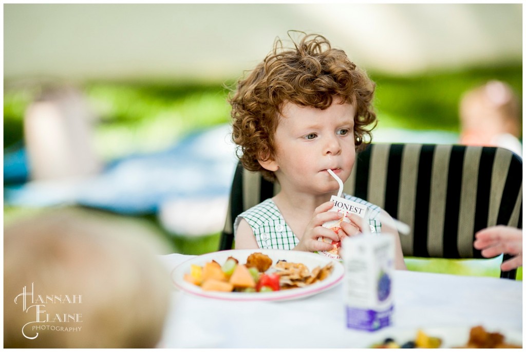 curly red headed boy takes a snack break