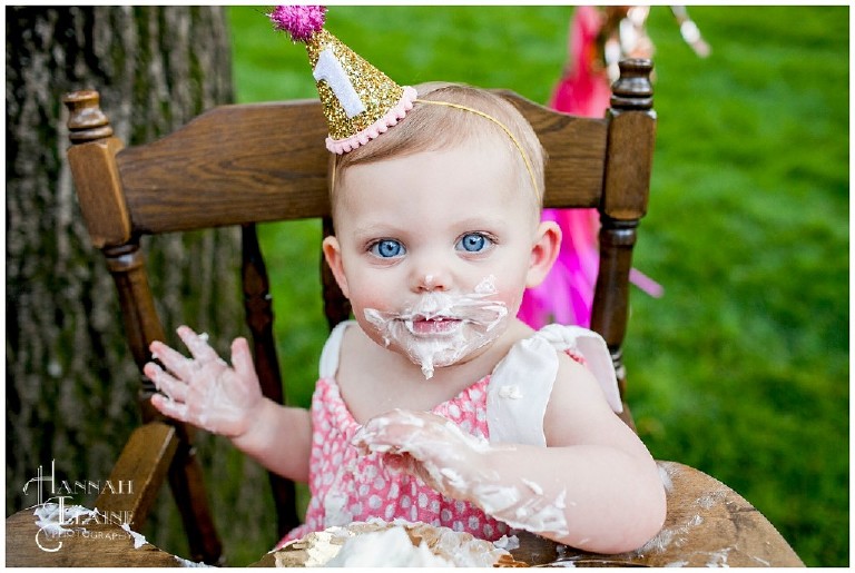 blue eyed girl in pink covered in cake