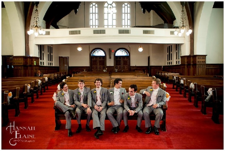 candid groomsmen photo sitting on front pew