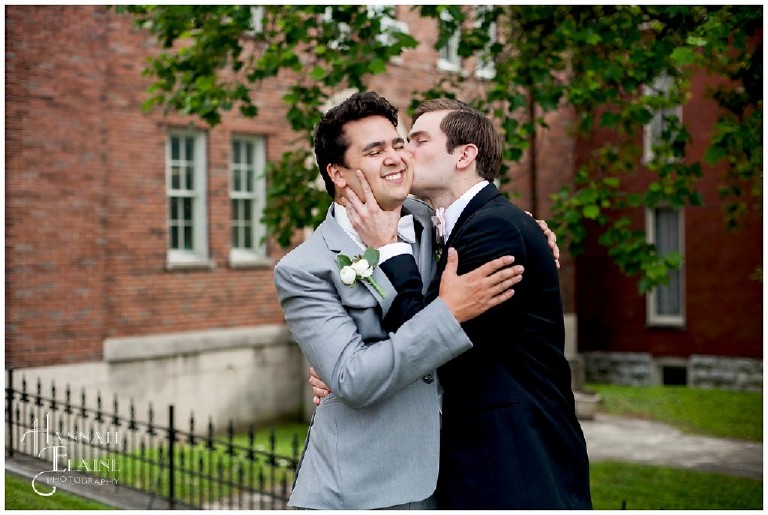 usher kisses the groom's cheek