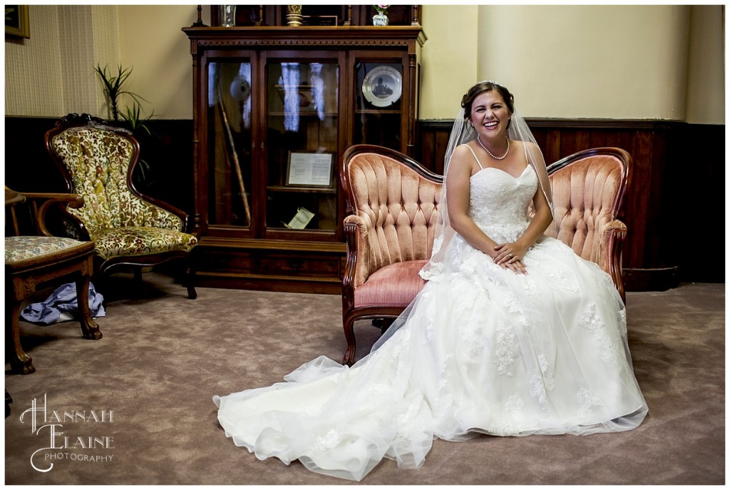 bride lounges on vintage pink setee 