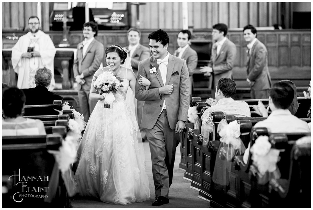 groom escorts his new bride back down the aisle