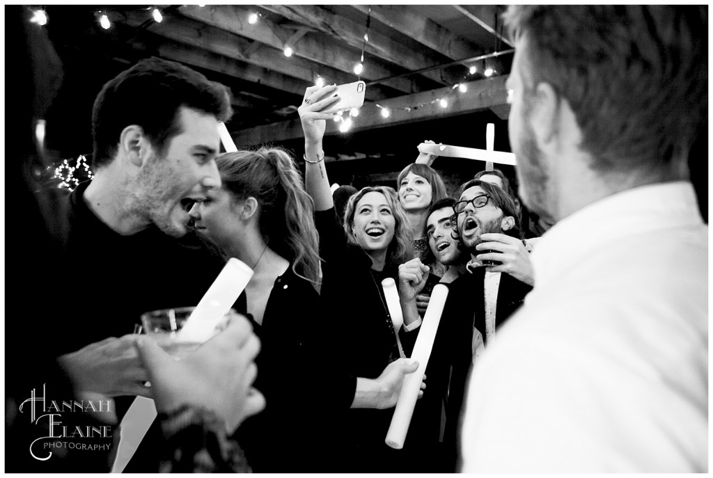 wedding guests crowd around for a selfie on the dance floor