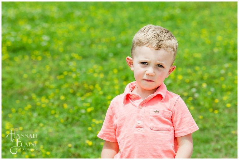 color image of a boy in pink shirt out in a field