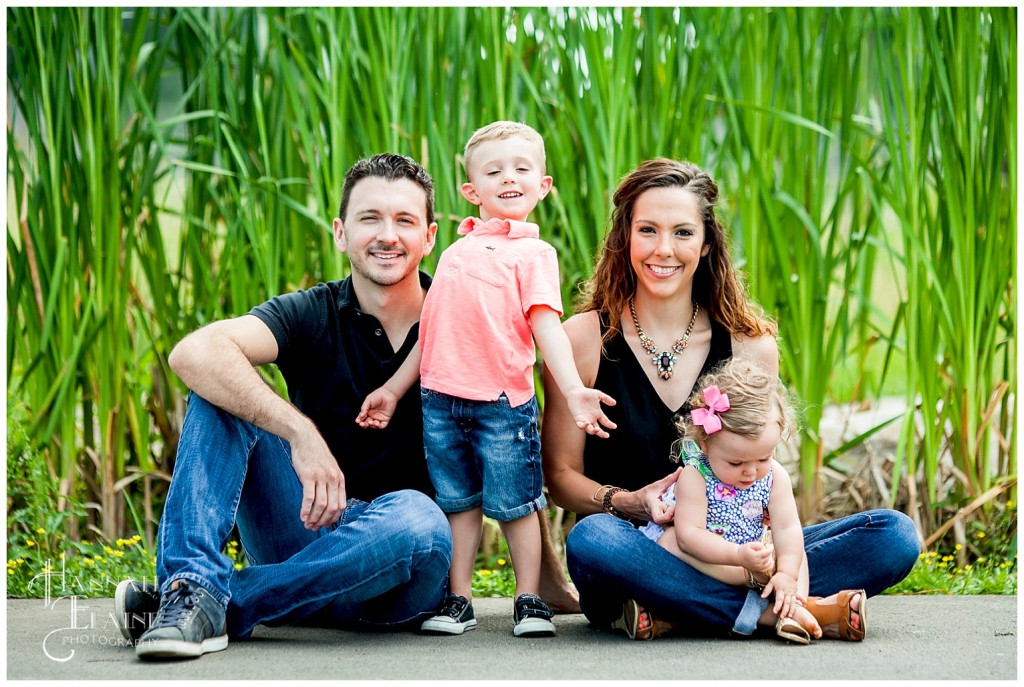 silly family photo in front of the tall reeds