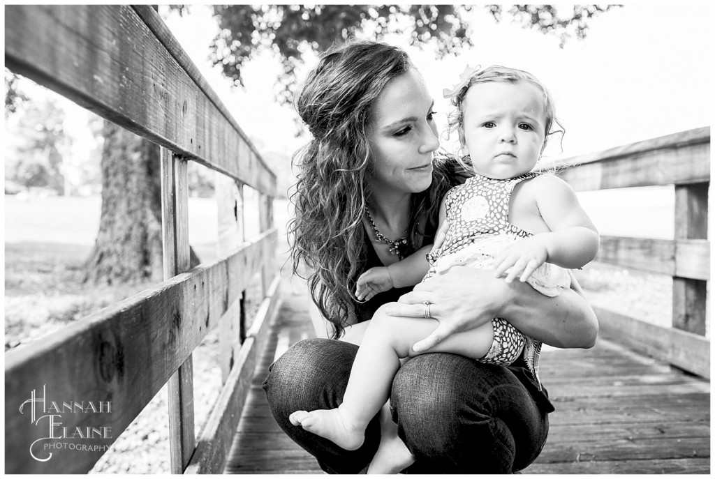 black and white picture of mom holding one year old daughter