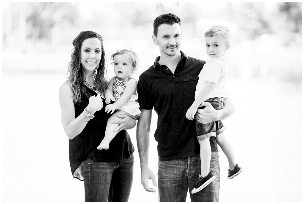 black and white family portrait in front of the lake 