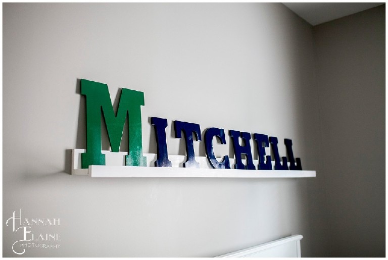 letters spelling mitchell on a shelf in a baby's nursery