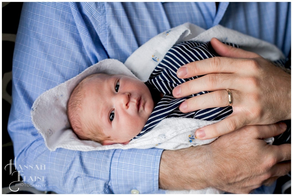  swaddled little boy stares into the camera