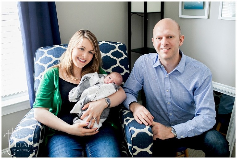 family of three takes their first portrait in the baby's nursery