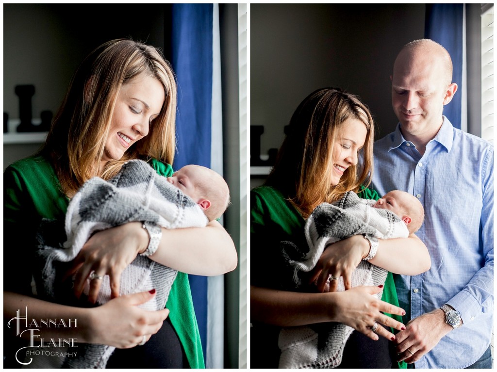 family stands next to the warm window light 