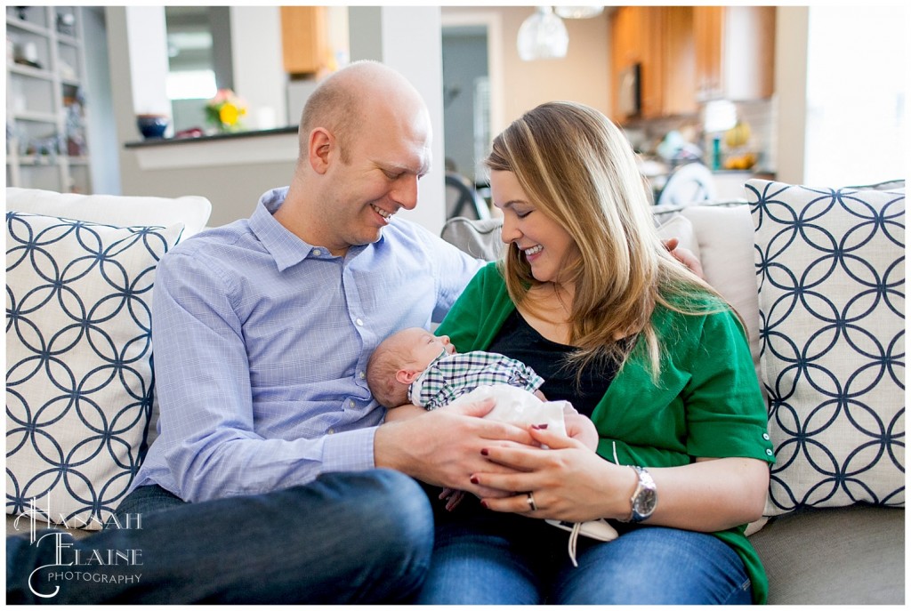 newborn baby in parent's arms