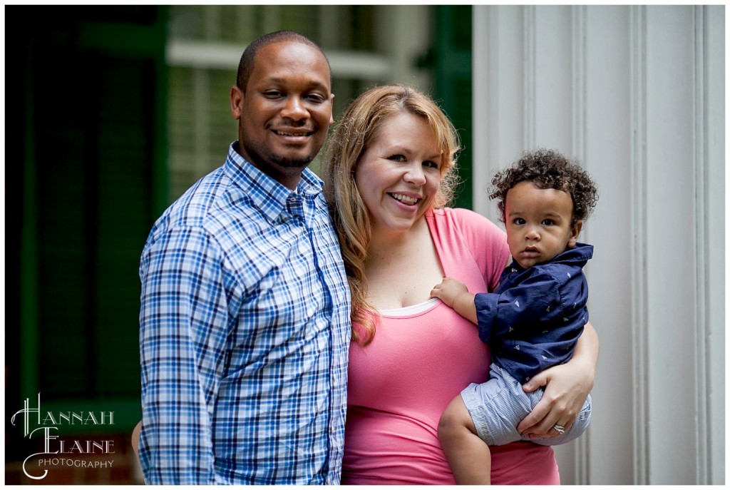 cute family of three take portraits on a rainy day