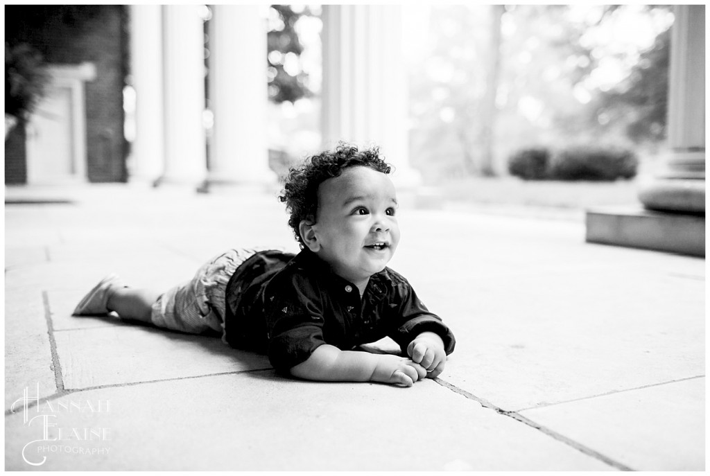 black and white image of little boy on his tummy