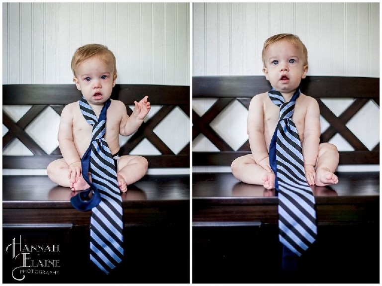 one year old boy wearing his dad's blue striped tie