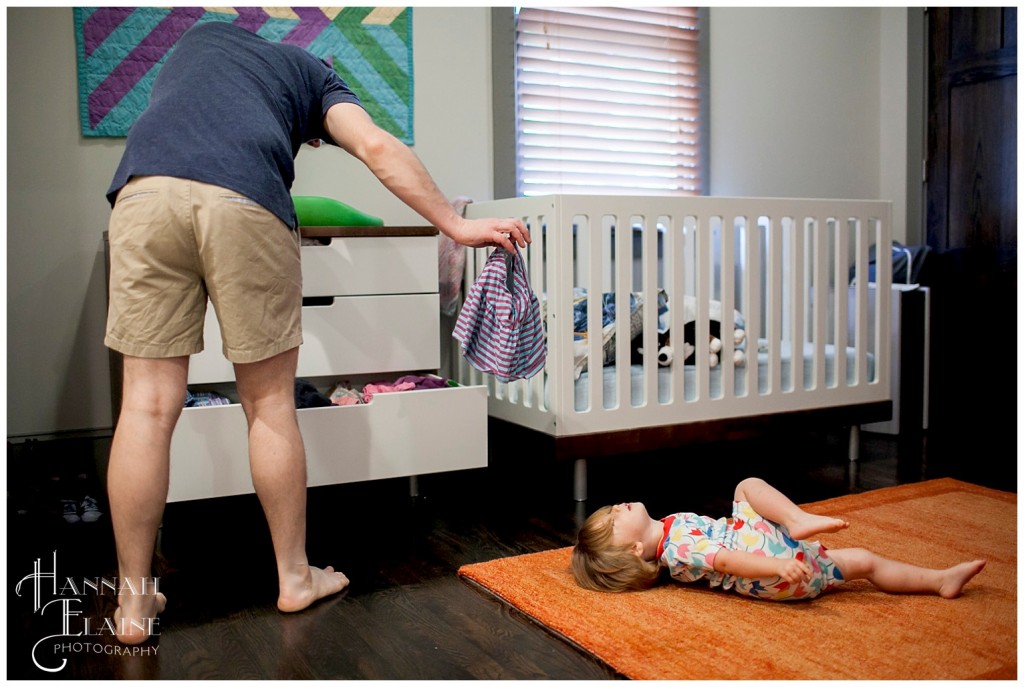 dad shows baby girl a skirt to wear