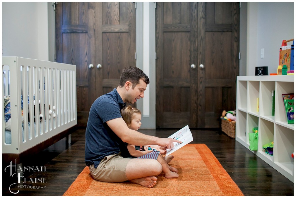 daddy reading a book to his daughter in her bedroom