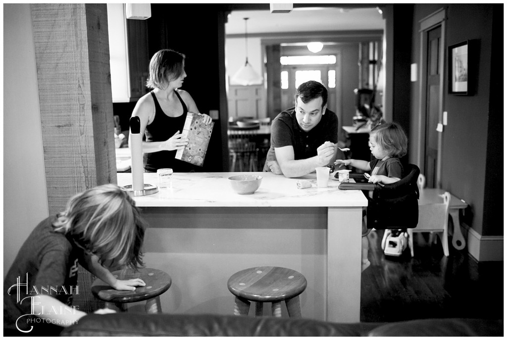 candid photo of family shares breakfast at the kitchen counter