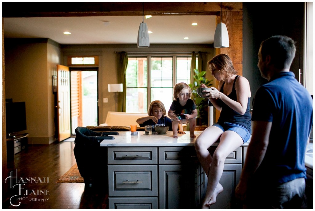 candid pic of family in a row eating in the kitchen