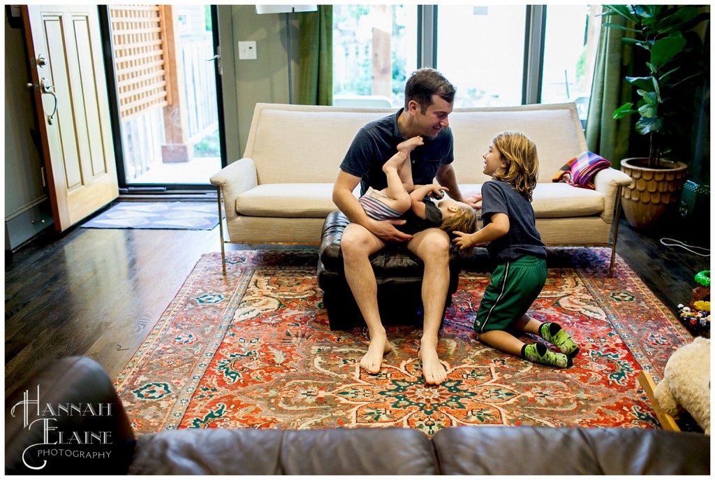 dad and brother tickle baby girl 