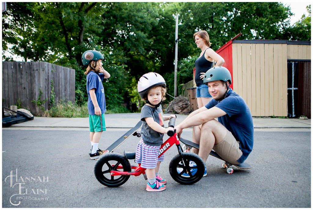 family rides bikes in the street in 12 south