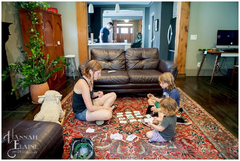 mom and son play sets card game in living room floor