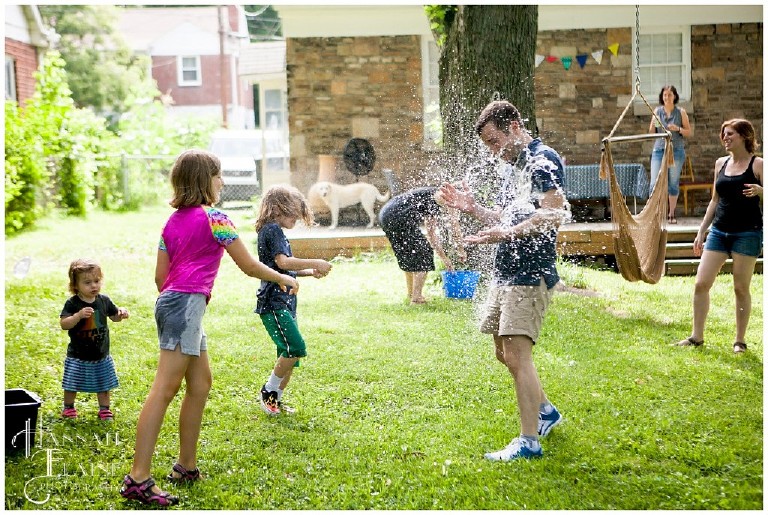 backyard family water balloon fight