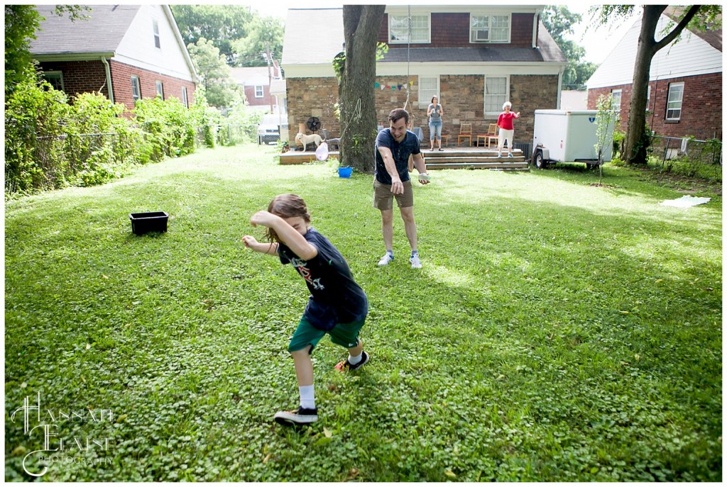 dad throws a water balloon at his son