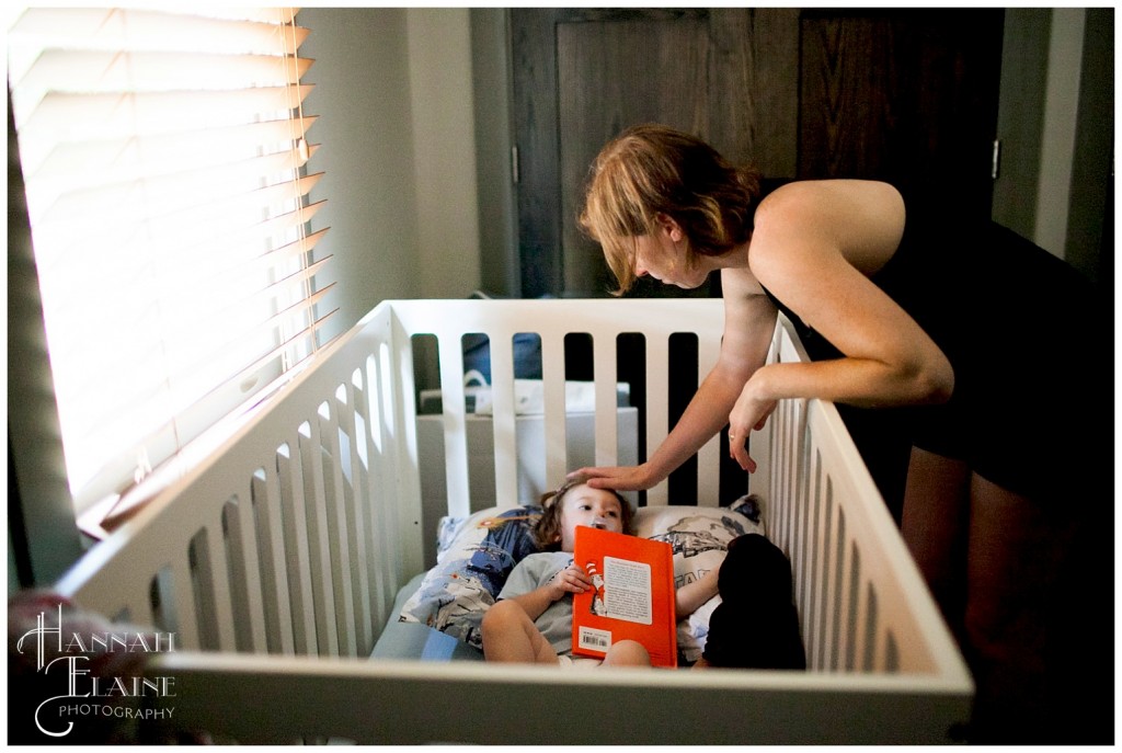 mom puts her baby girl down for a nap with green eggs and ham book