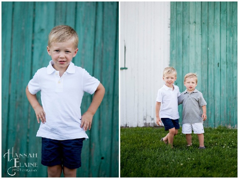 little boys in polo shirts hanging out in front of rustic barn