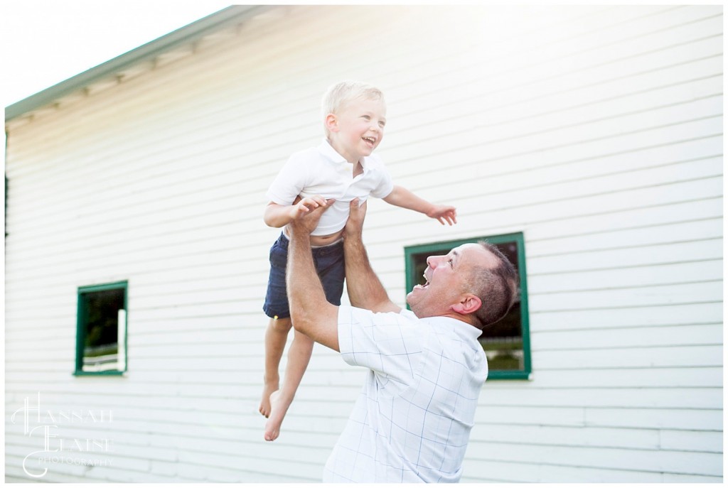 dad throws his first born up into the air