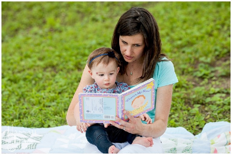 mom reads a book to her little girl