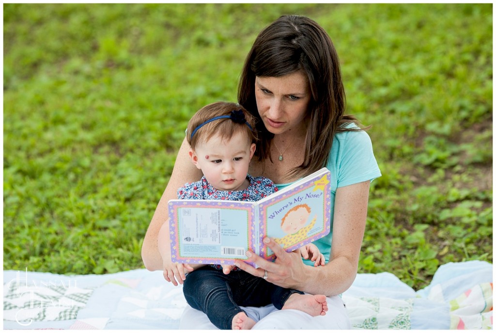 mom reads a book to her little girl