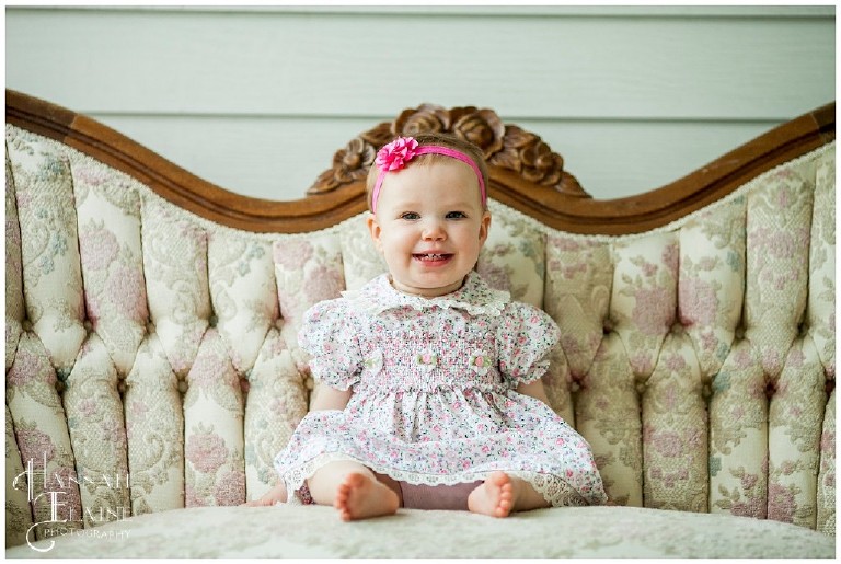sweet little smiling girl on retro couch