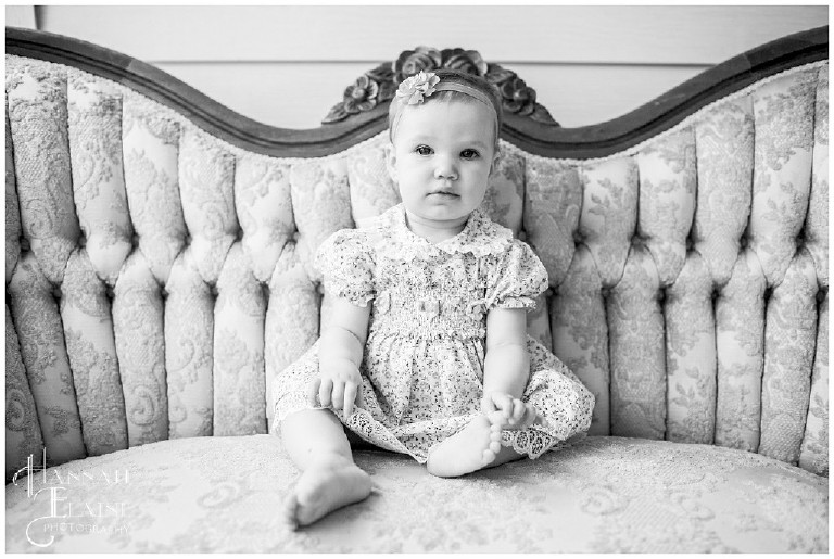 black and white photo of little girl on vintage couch