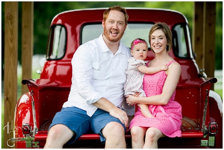 family photos on the bed of a vintage red truck