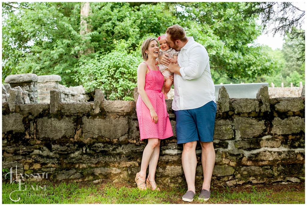 sweet family hanging by a stone wall